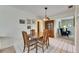 Inviting dining space with a classic wooden table and chairs, adjacent to a display cabinet at 12933 90Th Ave, Seminole, FL 33776