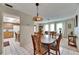 Cozy dining area with classic wooden table, chairs, and a decorative pendant light fixture at 12933 90Th Ave, Seminole, FL 33776