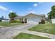 Exterior view of a one-story home with a two-car garage and well-maintained front lawn at 12933 90Th Ave, Seminole, FL 33776
