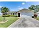 Exterior view of a one-story home with a two-car garage and well-maintained front lawn at 12933 90Th Ave, Seminole, FL 33776