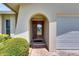 Inviting entryway featuring an arched doorway with a decorative glass front door and brick accents at 12933 90Th Ave, Seminole, FL 33776