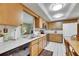 Open kitchen with wood cabinets, white countertops, and stainless steel appliances at 12933 90Th Ave, Seminole, FL 33776