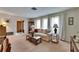 Bright living room featuring a large window with sheer curtains, a comfortable sofa, and stylish decor at 12933 90Th Ave, Seminole, FL 33776
