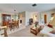 Open-concept living and dining area featuring neutral tones, tile flooring, and comfortable seating at 12933 90Th Ave, Seminole, FL 33776