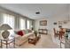 Bright living space featuring a cozy sofa, neutral decor, and a dining area with traditional-style furnishings at 12933 90Th Ave, Seminole, FL 33776