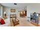 Comfortable living area with neutral tones, a plush sofa, and a dining area with classic wood furniture at 12933 90Th Ave, Seminole, FL 33776