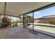 Enclosed patio with brick flooring and a view of the refreshing outdoor pool at 12933 90Th Ave, Seminole, FL 33776