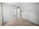 Bedroom featuring a closet, gray walls, and neutral carpeting with a view to a hallway at 14049 12Th St, Dade City, FL 33525