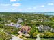 Aerial view of a home showcasing its prime location near the waterfront, beaches, and neighborhood at 1600 Magnolia Rd, Belleair, FL 33756