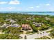 An aerial view of the home, showing the neighborhood, the waterfront, and the waterway at 1600 Magnolia Rd, Belleair, FL 33756