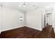 Empty bedroom featuring dark wood floors, white trim, and a bright window at 1600 Magnolia Rd, Belleair, FL 33756