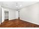 Bedroom with hardwood floors, ceiling fan, and a walk-in closet at 1600 Magnolia Rd, Belleair, FL 33756