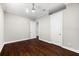 Bright bedroom with dark wood floors and white trim, featuring two entry doors at 1600 Magnolia Rd, Belleair, FL 33756