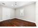 Bedroom features hardwood floors, bright window, and fresh white trim at 1600 Magnolia Rd, Belleair, FL 33756