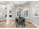 Bright dining room with fireplace and modern lighting, conveniently located near the kitchen and living room at 1600 Magnolia Rd, Belleair, FL 33756
