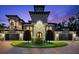 Elegant home featuring a barrel tile roof, manicured landscaping, circular driveway, and a grand entrance at 1600 Magnolia Rd, Belleair, FL 33756