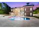 A luxury home exterior featuring a pool and a covered patio at 1600 Magnolia Rd, Belleair, FL 33756