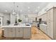 A modern kitchen with stainless appliances, a large island, and beautiful tile floors and light fixtures at 1600 Magnolia Rd, Belleair, FL 33756