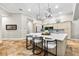 A modern kitchen with stainless appliances, a large island, and beautiful tile floors and light fixtures at 1600 Magnolia Rd, Belleair, FL 33756