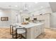 A modern kitchen with stainless appliances, a large island, and beautiful tile floors and light fixtures at 1600 Magnolia Rd, Belleair, FL 33756
