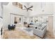 Open concept living room with tile floors and lots of natural light leading to the dining area at 1600 Magnolia Rd, Belleair, FL 33756