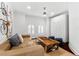 Stylish living room featuring a wood coffee table, shuttered windows, and comfortable seating at 1600 Magnolia Rd, Belleair, FL 33756