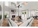 Bright living room with soaring ceilings, stone fireplace, tile floors, and access to the outdoor patio at 1600 Magnolia Rd, Belleair, FL 33756