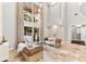 The open-concept living room boasts high ceilings, abundant light, and seamless access to the outdoor patio at 1600 Magnolia Rd, Belleair, FL 33756