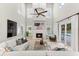 A spacious living room with vaulted ceilings, a fireplace, and a comfortable seating area at 1600 Magnolia Rd, Belleair, FL 33756