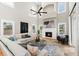 A spacious living room with vaulted ceilings, a fireplace, and a comfortable seating area at 1600 Magnolia Rd, Belleair, FL 33756