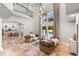 Bright living room with high ceilings and an open layout to the outdoor pool area and modern kitchen at 1600 Magnolia Rd, Belleair, FL 33756