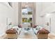 Bright living room with soaring ceilings, modern light fixtures, and a view of the pool at 1600 Magnolia Rd, Belleair, FL 33756