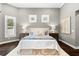 Spacious main bedroom with gray walls, lots of light, and wood floors at 1600 Magnolia Rd, Belleair, FL 33756