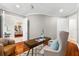 Bright office space with hardwood floors and views into the formal dining room at 1600 Magnolia Rd, Belleair, FL 33756