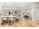 Bright open-concept kitchen, dining, and living area with travertine floors, modern design elements, and great natural light at 1600 Magnolia Rd, Belleair, FL 33756