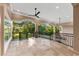 Covered patio with decorative railings offers views of the landscaped backyard at 1600 Magnolia Rd, Belleair, FL 33756