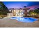 Stunning outdoor space showcasing a pool, spa, and spiral staircase leading to the upper levels at 1600 Magnolia Rd, Belleair, FL 33756