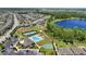 An aerial view showcases a pond, park, playground, community pool, and surrounding neighborhood at 1741 Cherry Walk Rd, Lutz, FL 33558