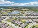 An aerial view of a well-planned community featuring lovely homes, green spaces, and serene lakes under a blue sky at 1741 Cherry Walk Rd, Lutz, FL 33558