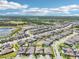 An aerial view showcases a residential neighborhood with manicured lawns, modern homes and community lakes under a blue sky at 1741 Cherry Walk Rd, Lutz, FL 33558