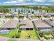 An aerial view shows the fenced backyard with a well-maintained lawn, screened-in patio, playground and pool at 1741 Cherry Walk Rd, Lutz, FL 33558