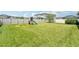 A spacious backyard with a playset on green grass at 1741 Cherry Walk Rd, Lutz, FL 33558