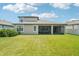 Spacious backyard with a screened lanai, perfect for outdoor relaxation and entertaining at 1741 Cherry Walk Rd, Lutz, FL 33558