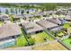An aerial view shows a fenced backyard with a well-maintained lawn, screened-in patio and a swimming pool at 1741 Cherry Walk Rd, Lutz, FL 33558