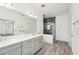 Stylish bathroom showcasing double vanity, large mirror, and glass shower at 1741 Cherry Walk Rd, Lutz, FL 33558
