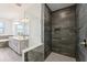 Modern bathroom featuring a double vanity, soaking tub, and walk-in shower with elegant tile and glass enclosure at 1741 Cherry Walk Rd, Lutz, FL 33558