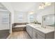 Bathroom with soaking tub, double vanity, and view of Main Bedroom at 1741 Cherry Walk Rd, Lutz, FL 33558