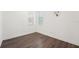 Bedroom with wood floors, white walls, closet, and natural light at 1741 Cherry Walk Rd, Lutz, FL 33558