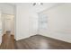 Bedroom with wood floors, white walls, closet, and natural light at 1741 Cherry Walk Rd, Lutz, FL 33558