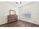 Bedroom featuring a ceiling fan, wood-look flooring, and a dresser at 1741 Cherry Walk Rd, Lutz, FL 33558